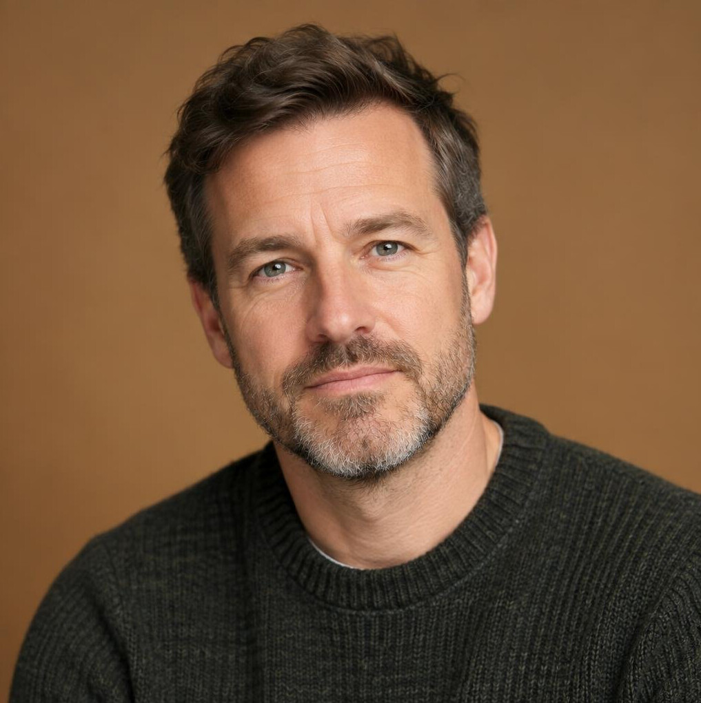 Professional headshot of a white British man culture and ethics lead