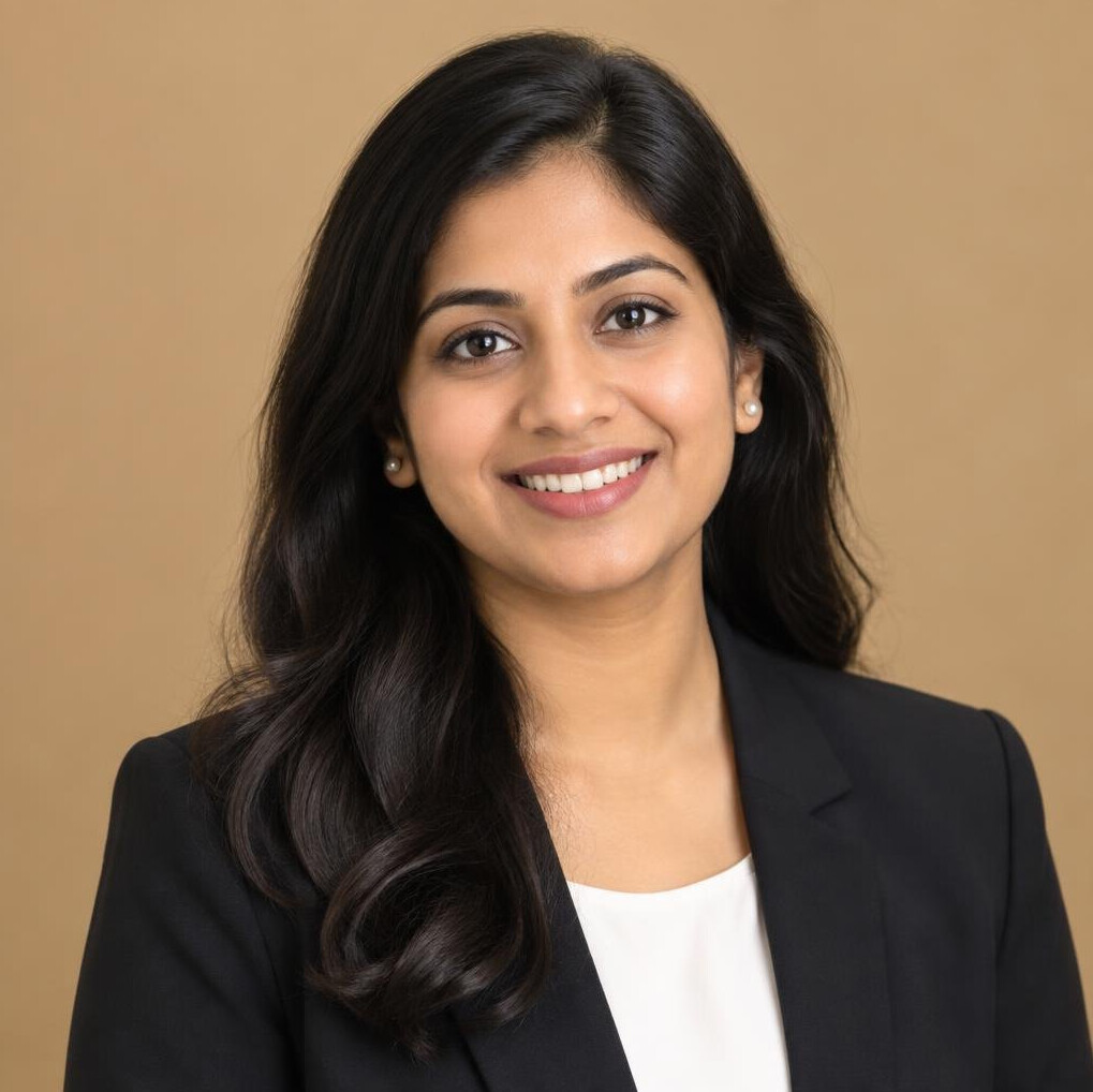 Professional headshot of a South Asian woman interview coordinator